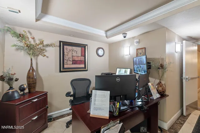 a view of a workspace with furniture and a lamp
