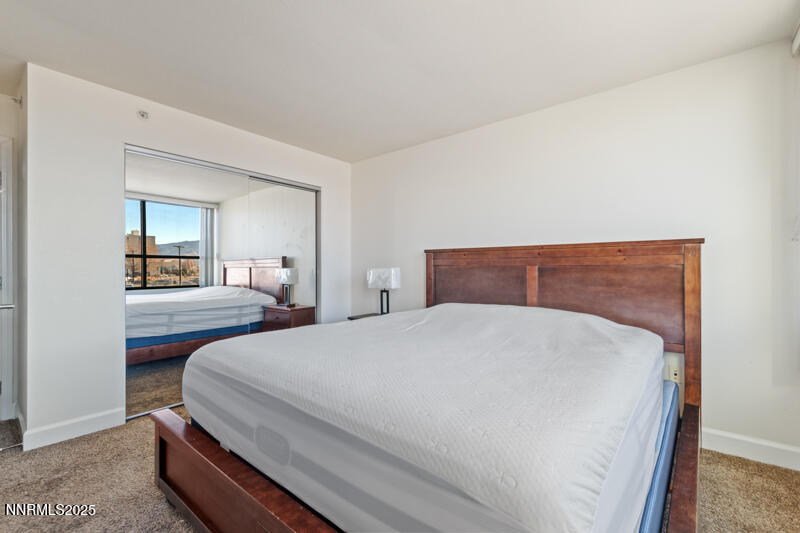 450 North Arlington Avenue, Unit 302 Reno, NV 89503 - Photo 6 of 21 a bedroom with a large bed and wooden floor