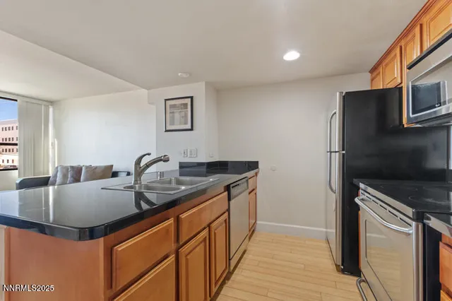 a kitchen with stainless steel appliances granite countertop a sink stove and refrigerator