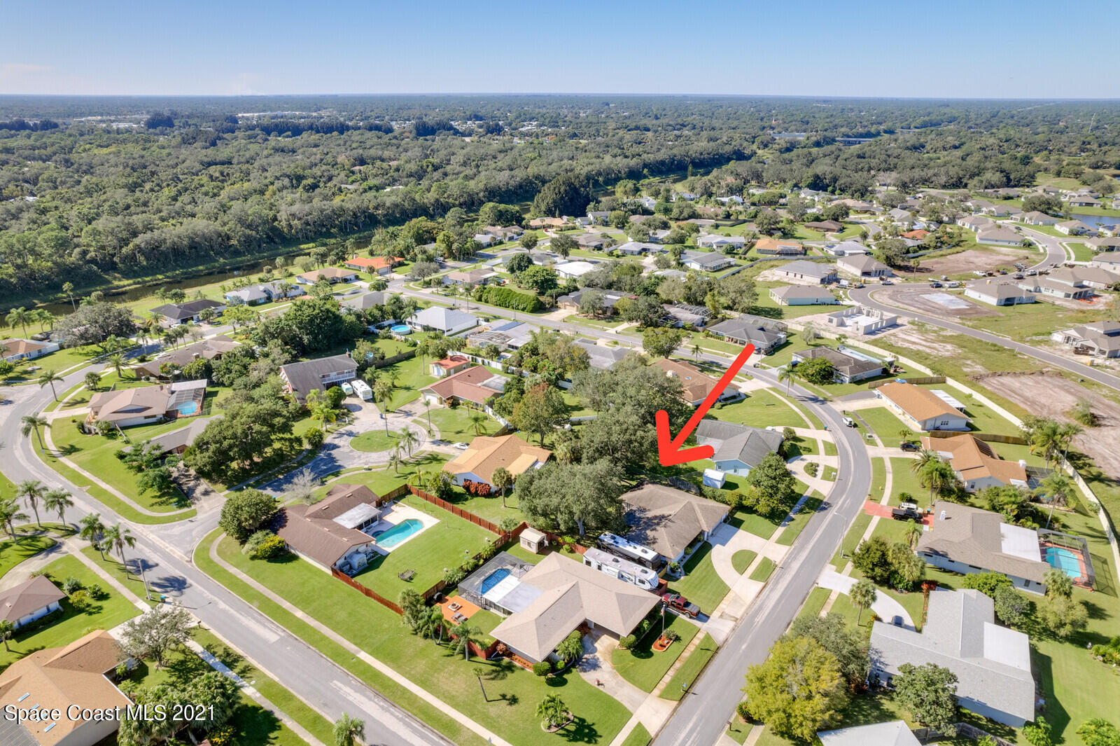 791 Montclair Road Northeast Palm Bay, FL 32905 - Photo 12 of 69 an aerial view of residential houses with outdoor space and trees