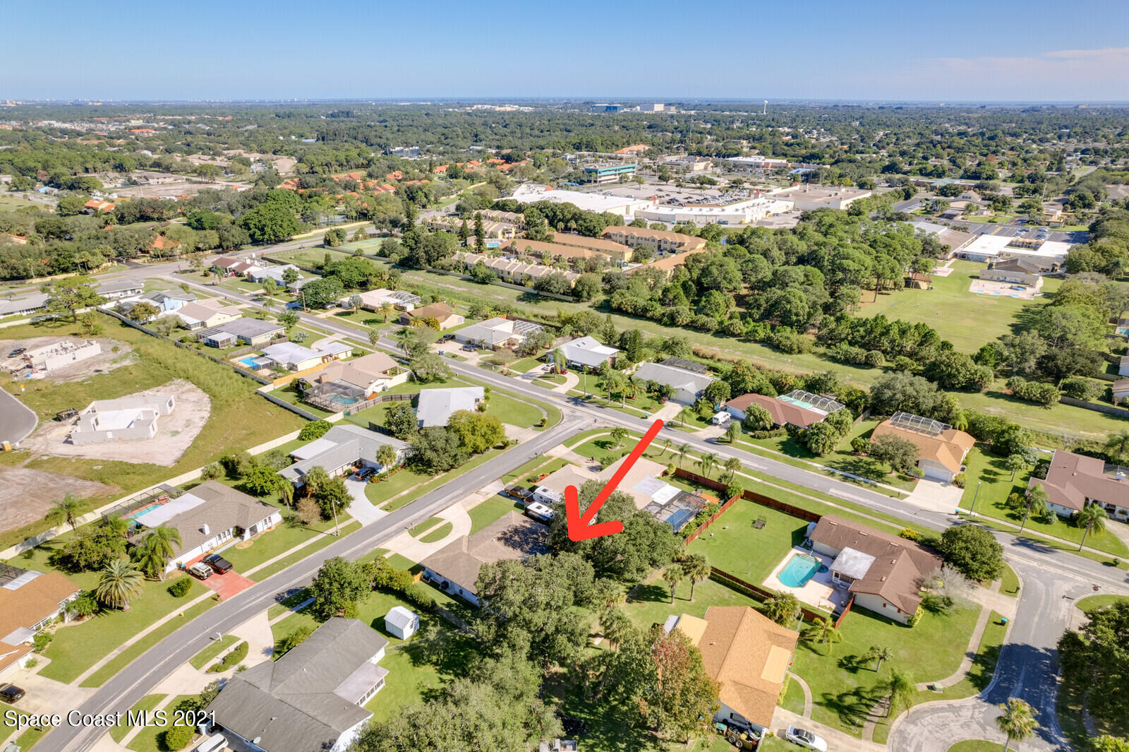 791 Montclair Road Northeast Palm Bay, FL 32905 - Photo 16 of 69 an aerial view of residential houses with outdoor space and trees
