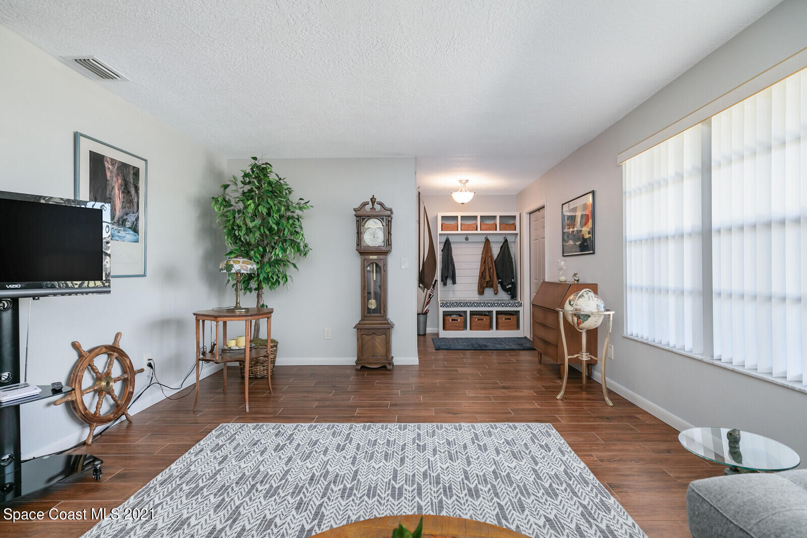 791 Montclair Road Northeast Palm Bay, FL 32905 - Photo 20 of 69 a living room with furniture rug and a flat screen tv
