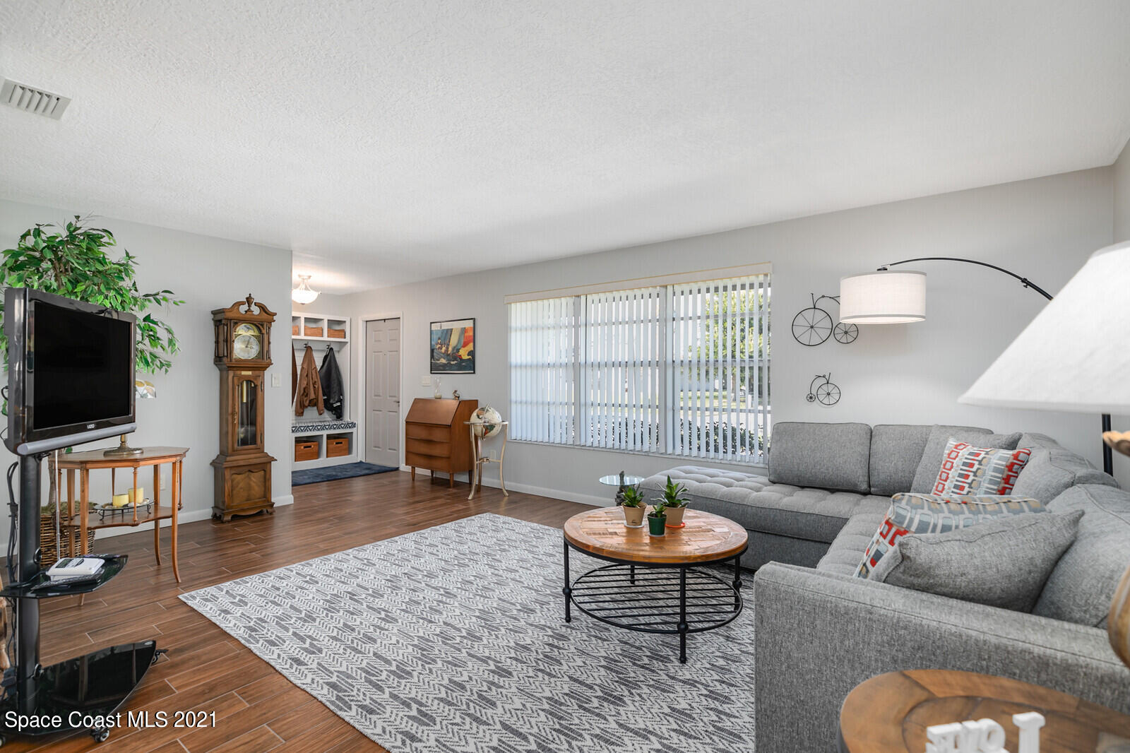 791 Montclair Road Northeast Palm Bay, FL 32905 - Photo 21 of 69 a living room with furniture and a flat screen tv