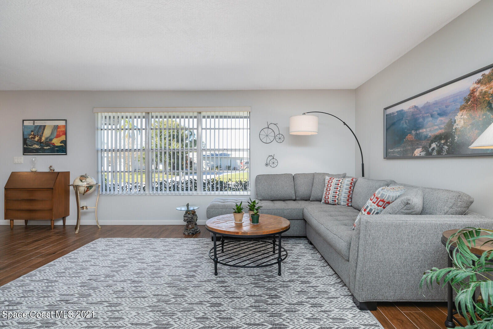 791 Montclair Road Northeast Palm Bay, FL 32905 - Photo 22 of 69 a living room with furniture a rug and a large window