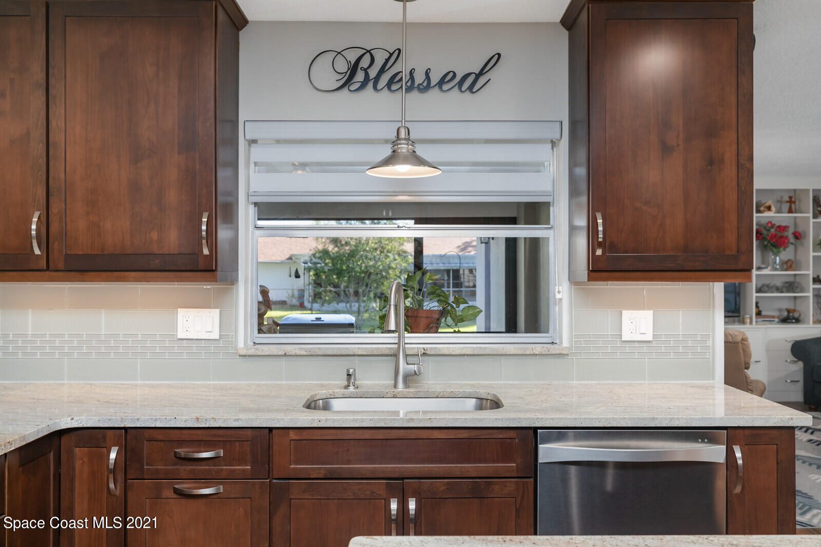 791 Montclair Road Northeast Palm Bay, FL 32905 - Photo 27 of 69 a kitchen with a sink and a window