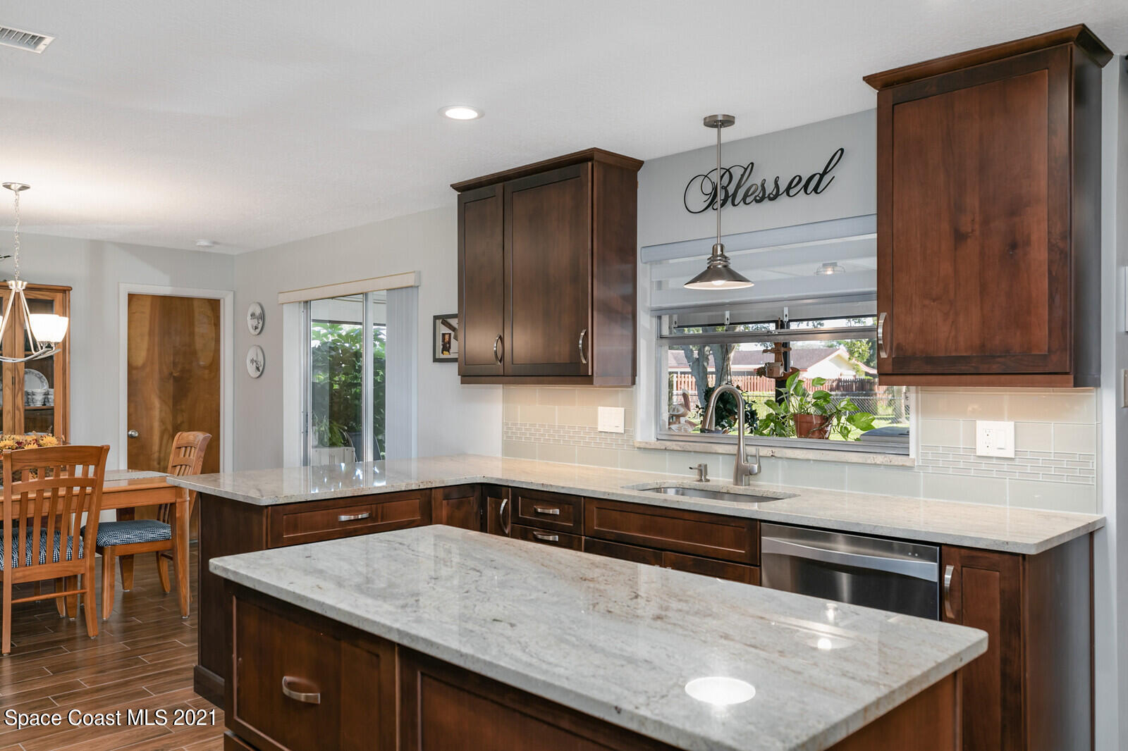 791 Montclair Road Northeast Palm Bay, FL 32905 - Photo 28 of 69 a kitchen with stainless steel appliances granite countertop a sink a stove and a microwave