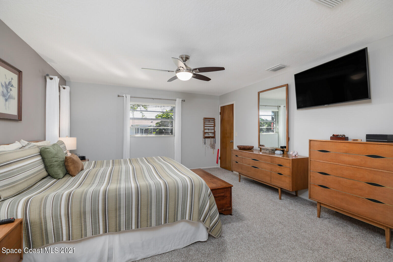 791 Montclair Road Northeast Palm Bay, FL 32905 - Photo 34 of 69 a bedroom with a bed and a flat screen tv
