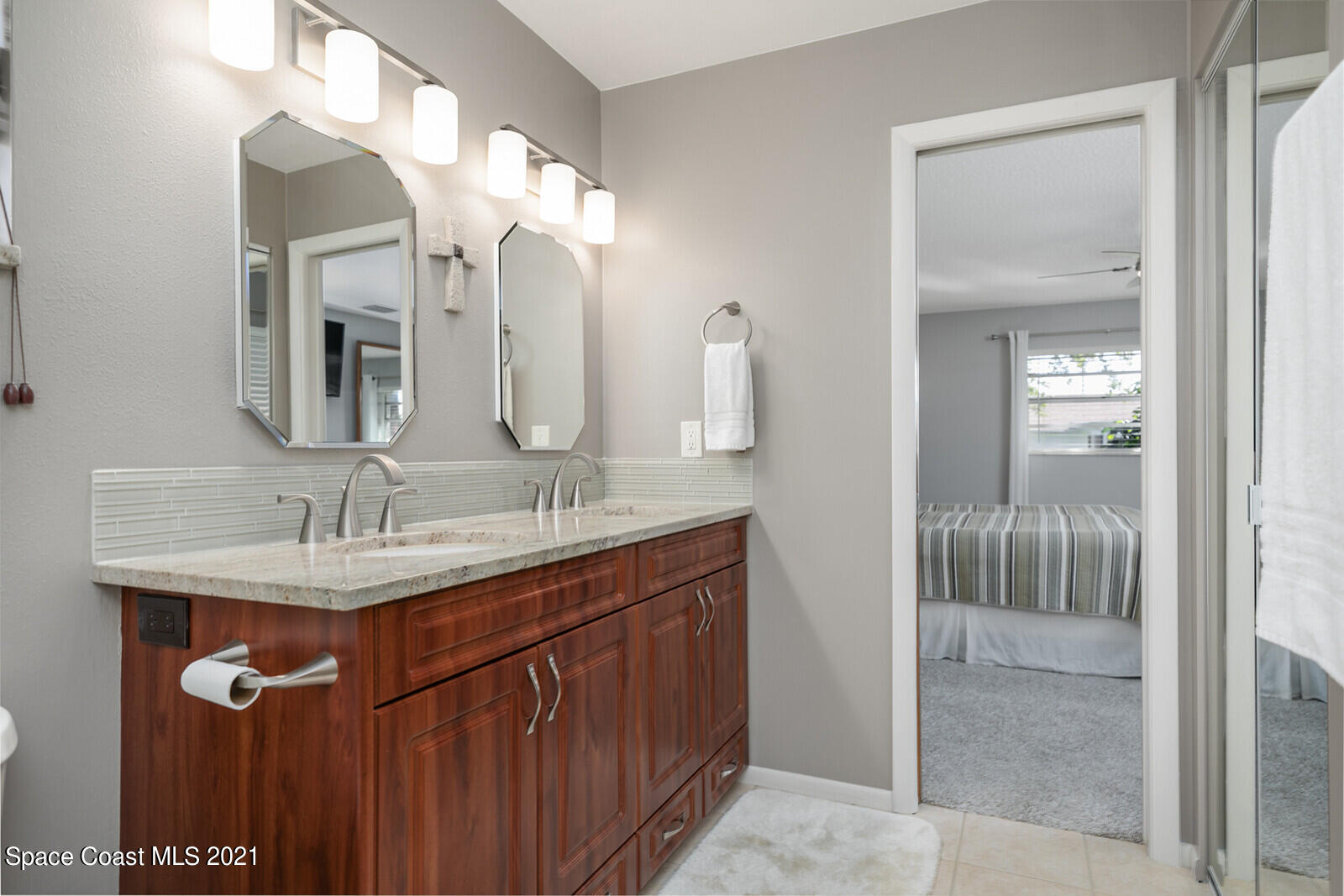 791 Montclair Road Northeast Palm Bay, FL 32905 - Photo 37 of 69 a bathroom with a granite countertop sink and a mirror