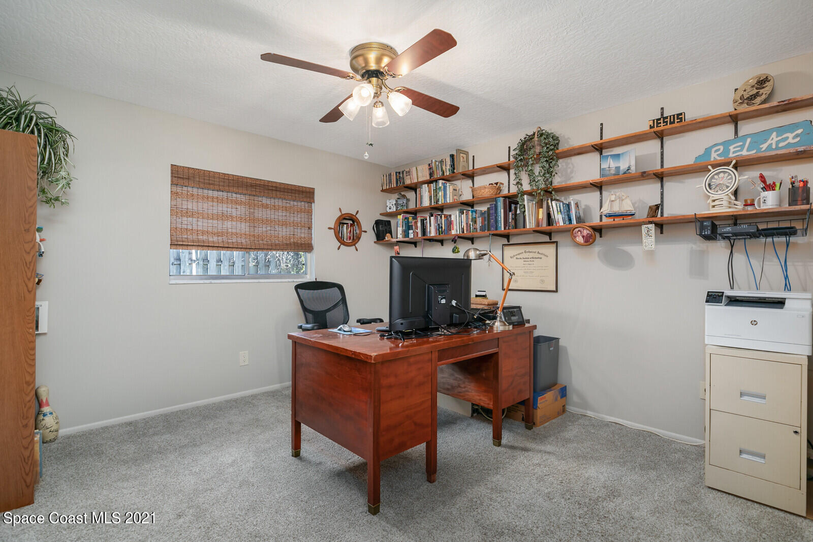 791 Montclair Road Northeast Palm Bay, FL 32905 - Photo 38 of 69 a view of a workspace with a bookshelf