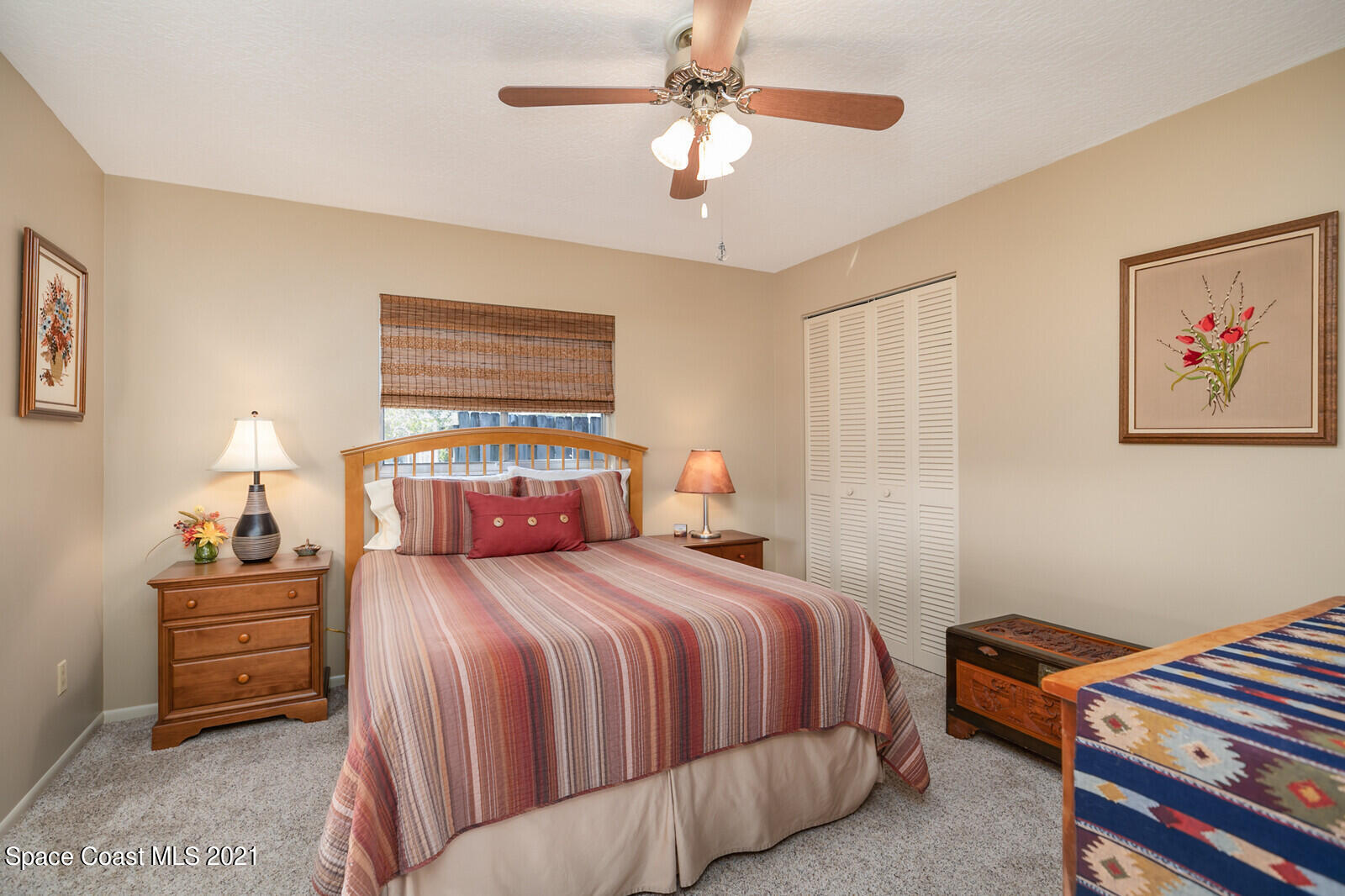 791 Montclair Road Northeast Palm Bay, FL 32905 - Photo 40 of 69 a bedroom with a bed and a chandelier