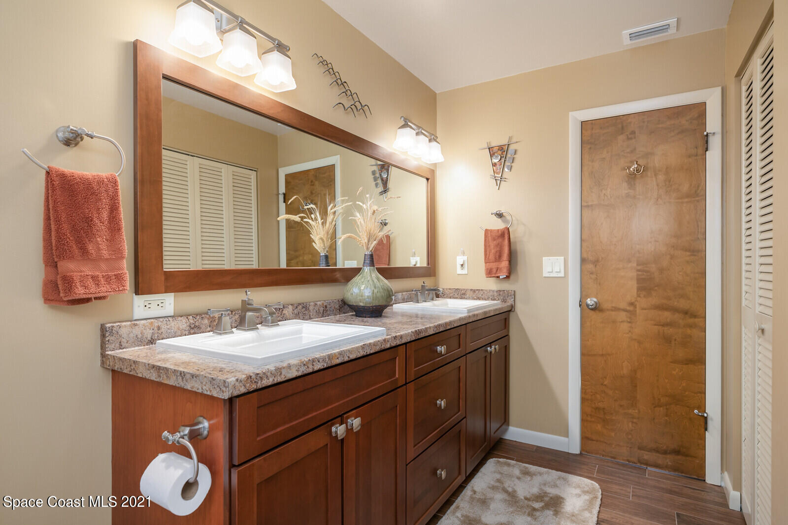 791 Montclair Road Northeast Palm Bay, FL 32905 - Photo 43 of 69 a bathroom with a granite countertop sink and a mirror