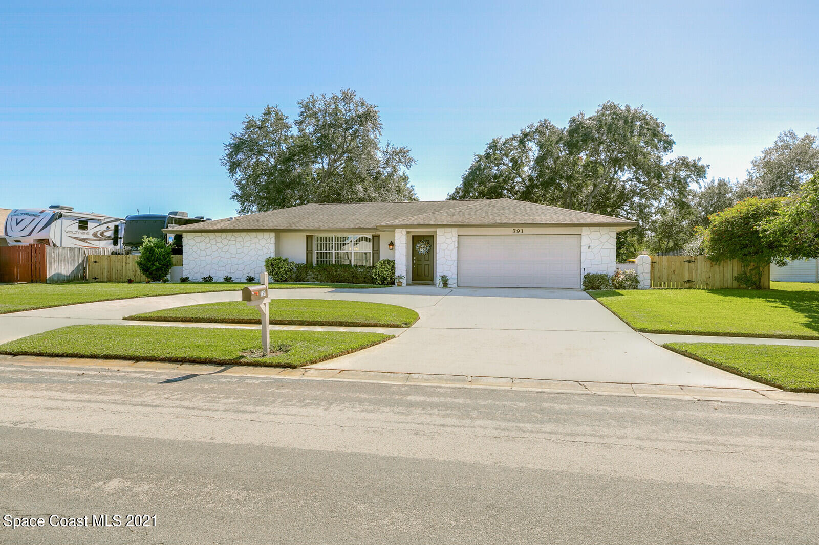 791 Montclair Road Northeast Palm Bay, FL 32905 - Photo 49 of 69 a view of a house with a big yard and large trees