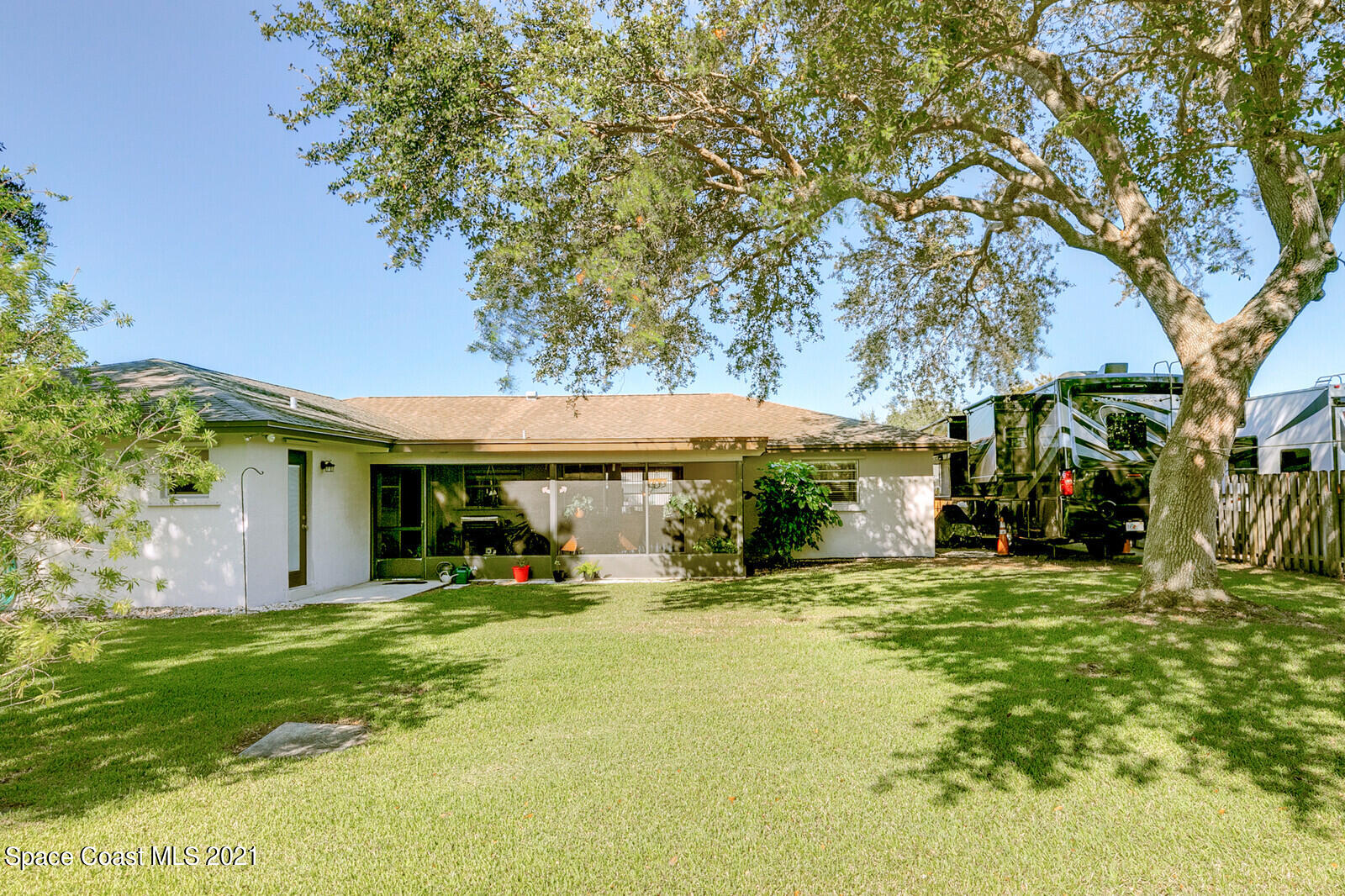 791 Montclair Road Northeast Palm Bay, FL 32905 - Photo 54 of 69 a view of a house with a yard and tree s