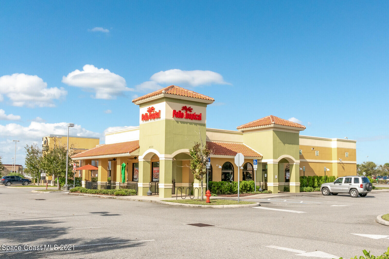 791 Montclair Road Northeast Palm Bay, FL 32905 - Photo 59 of 69 a view of a brick building next to a road