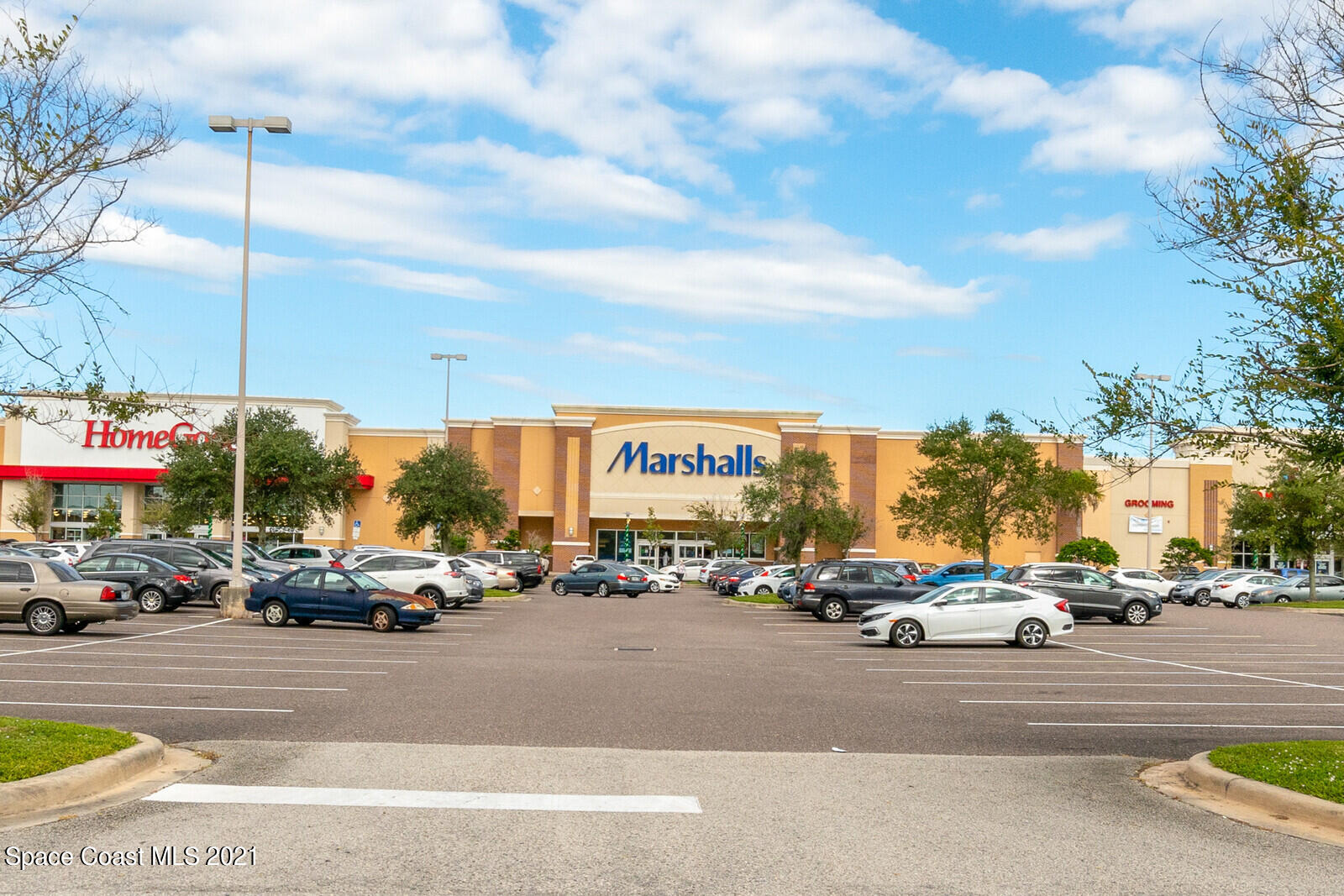 791 Montclair Road Northeast Palm Bay, FL 32905 - Photo 63 of 69 a view of road with card parked on side and retail shops