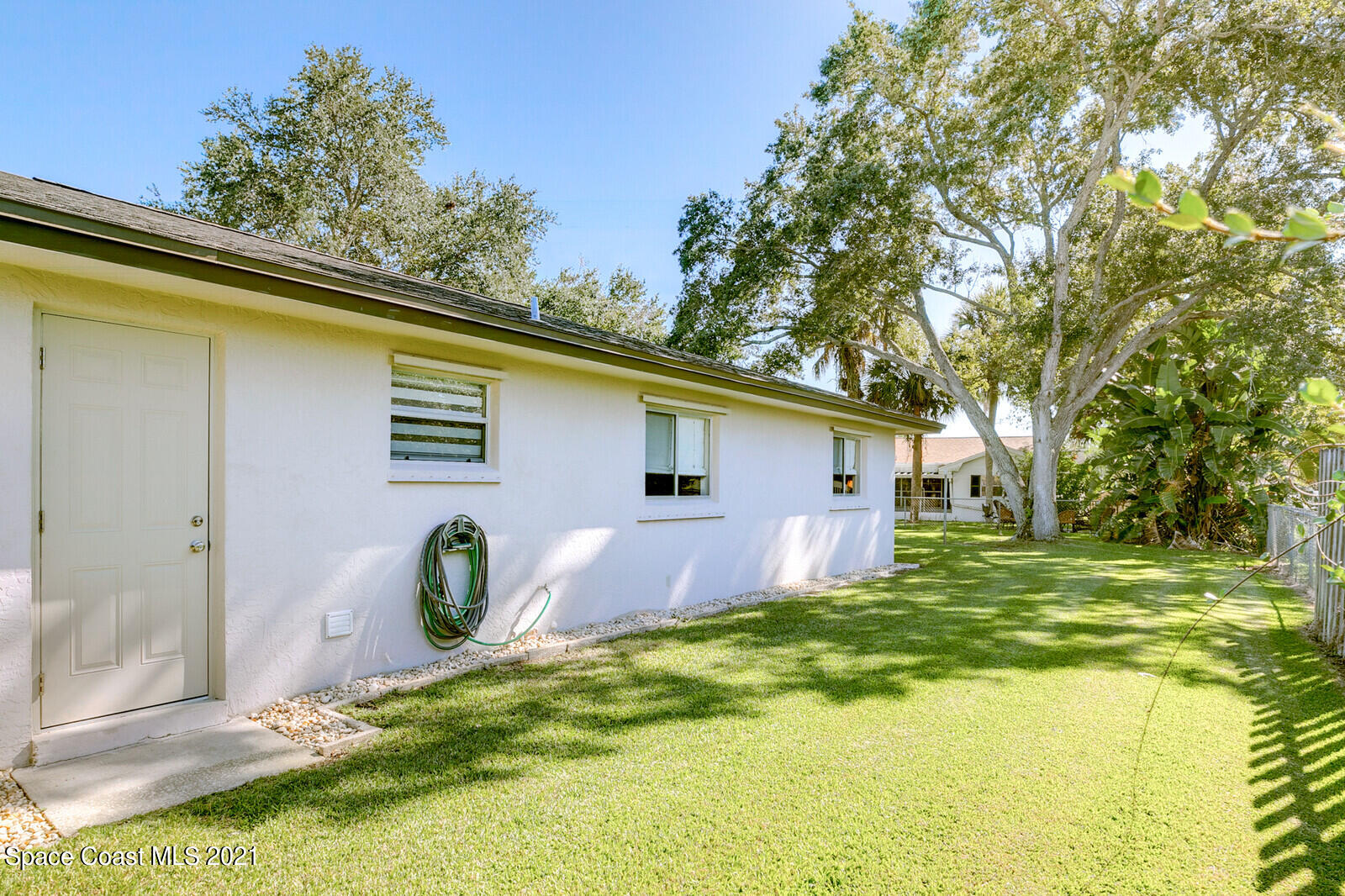 791 Montclair Road Northeast Palm Bay, FL 32905 - Photo 9 of 69 a view of a backyard with a large tree