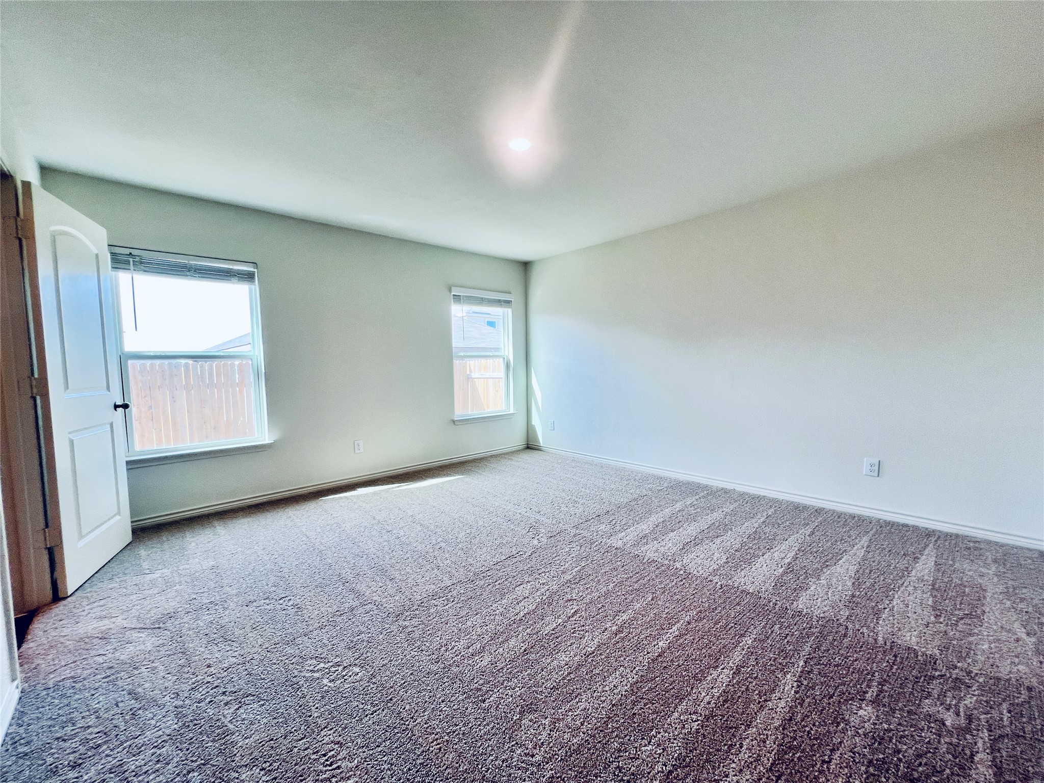 520 Locksley Cove Jarrell, TX 76537 - Photo 14 of 27 A spacious bedroom with a neutral palette and plush carpeting.