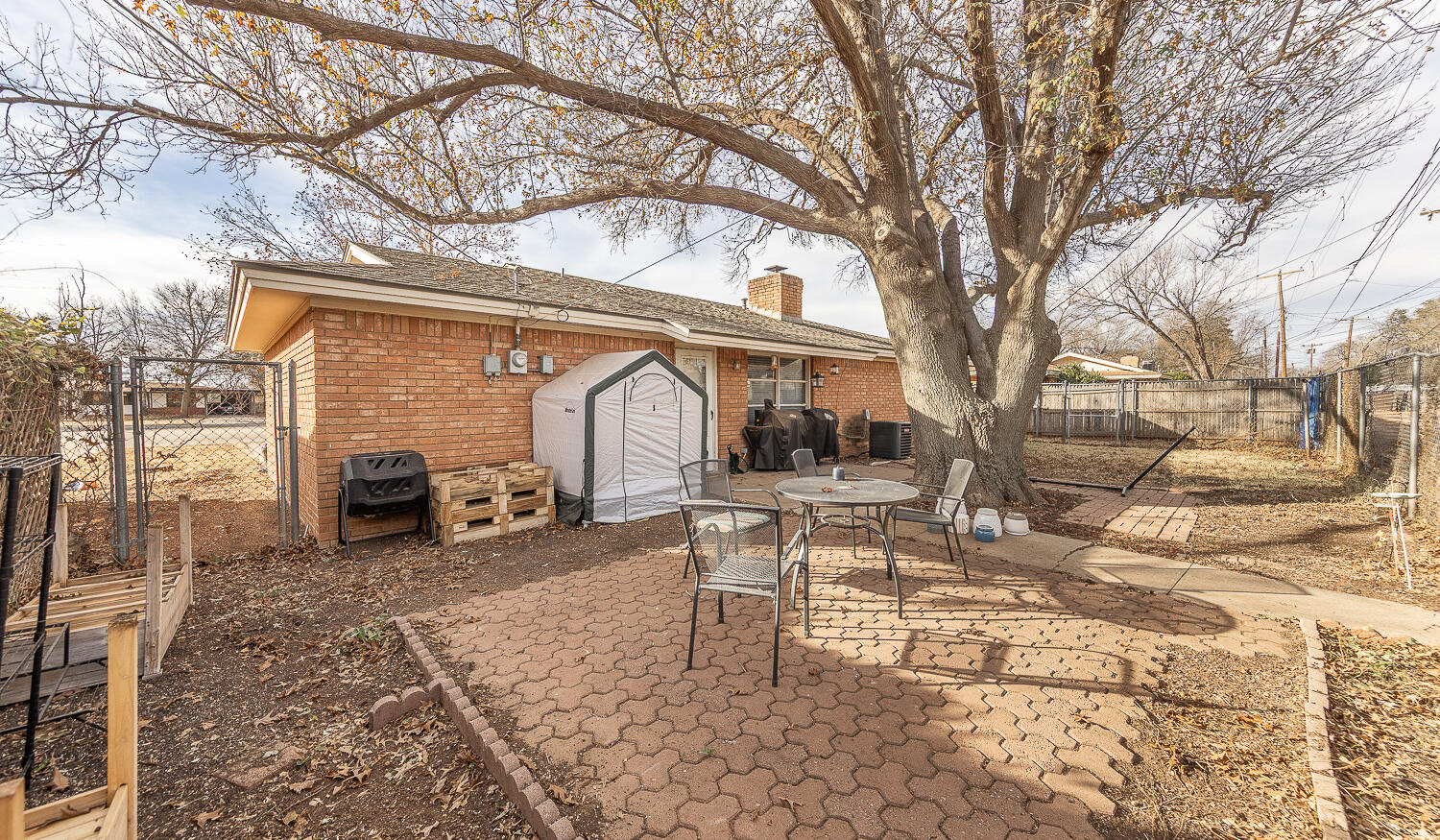 2410 33rd Street Lubbock, TX 79411 - Photo 2 of 14 a view of a yard with a patio and a fire pit