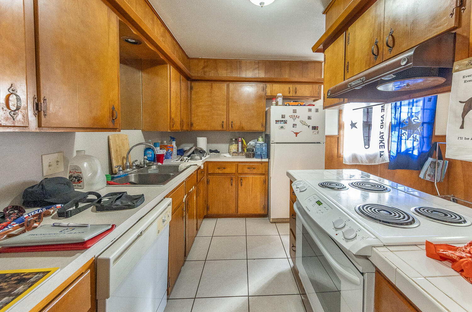 2410 33rd Street Lubbock, TX 79411 - Photo 4 of 14 a kitchen with a sink a stove and cabinets