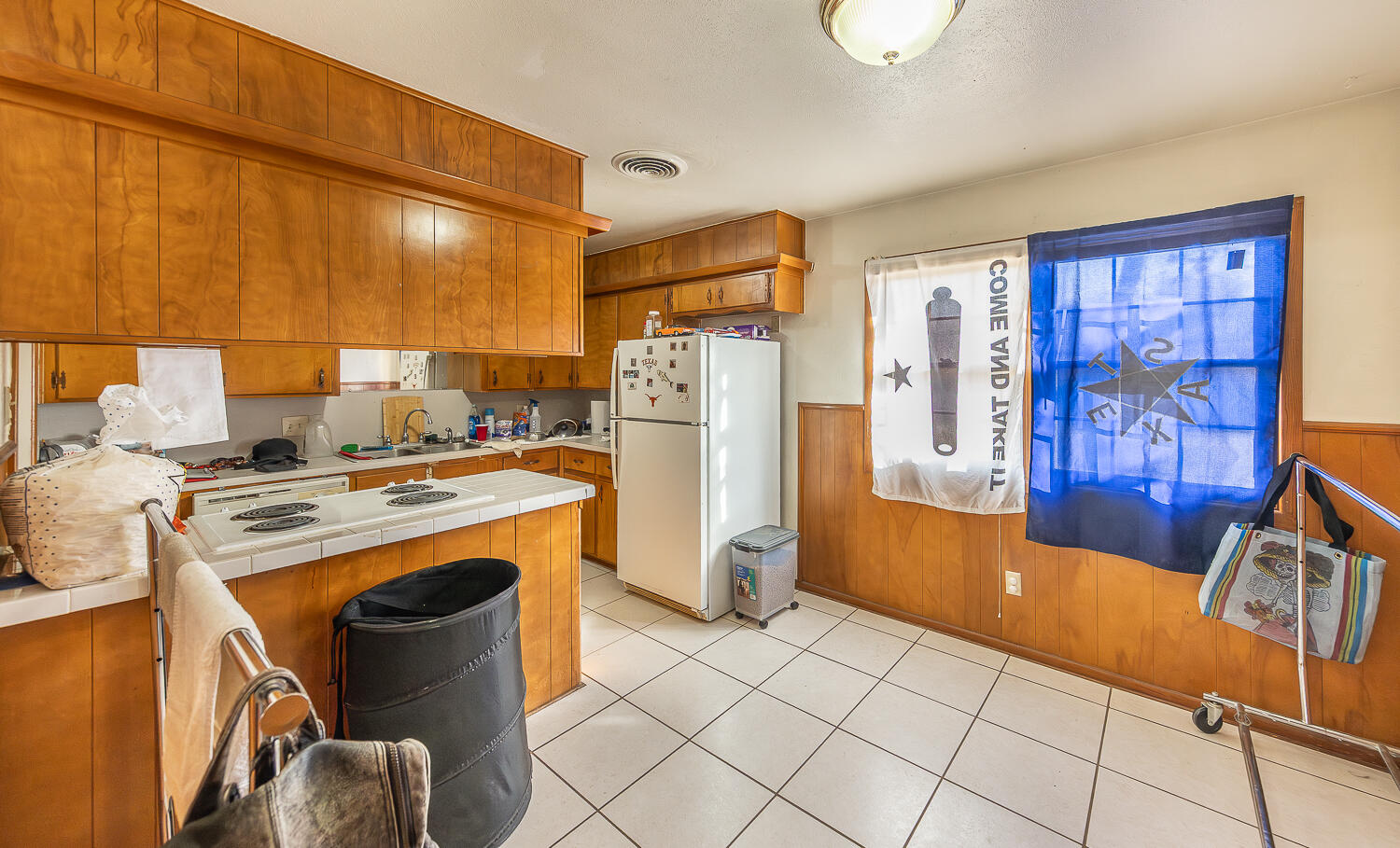 2410 33rd Street Lubbock, TX 79411 - Photo 7 of 14 a kitchen with refrigerator and table