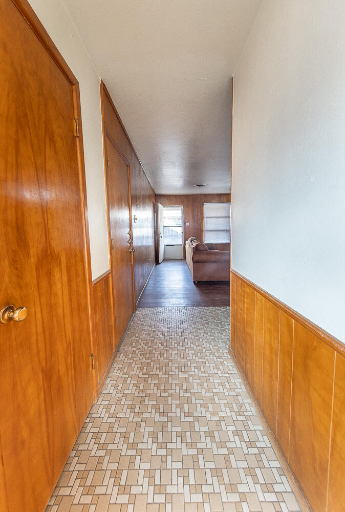 2410 33rd Street Lubbock, TX 79411 - Photo 8 of 14 a view of a hallway with wooden floor and furniture