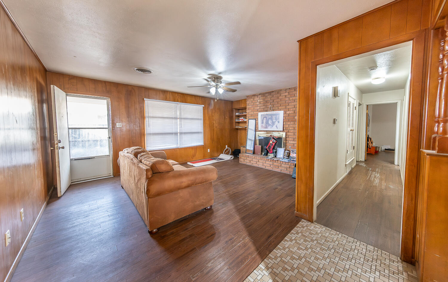 2410 33rd Street Lubbock, TX 79411 - Photo 9 of 14 a living room with furniture and a chandelier