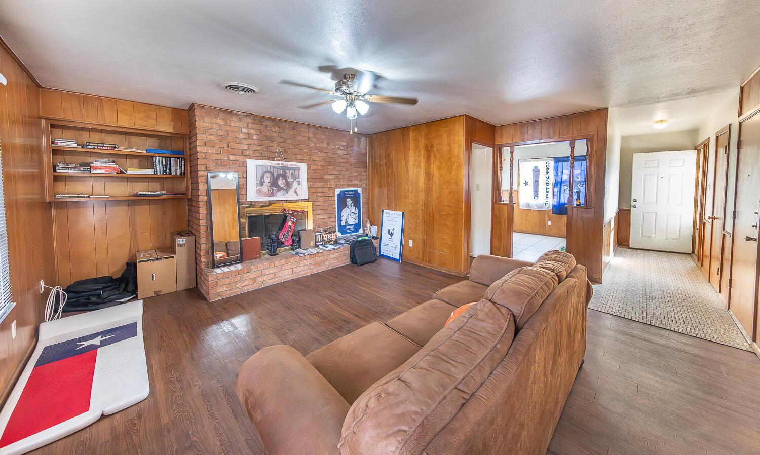 2410 33rd Street Lubbock, TX 79411 - Photo 10 of 14 a living room with furniture and a chandelier
