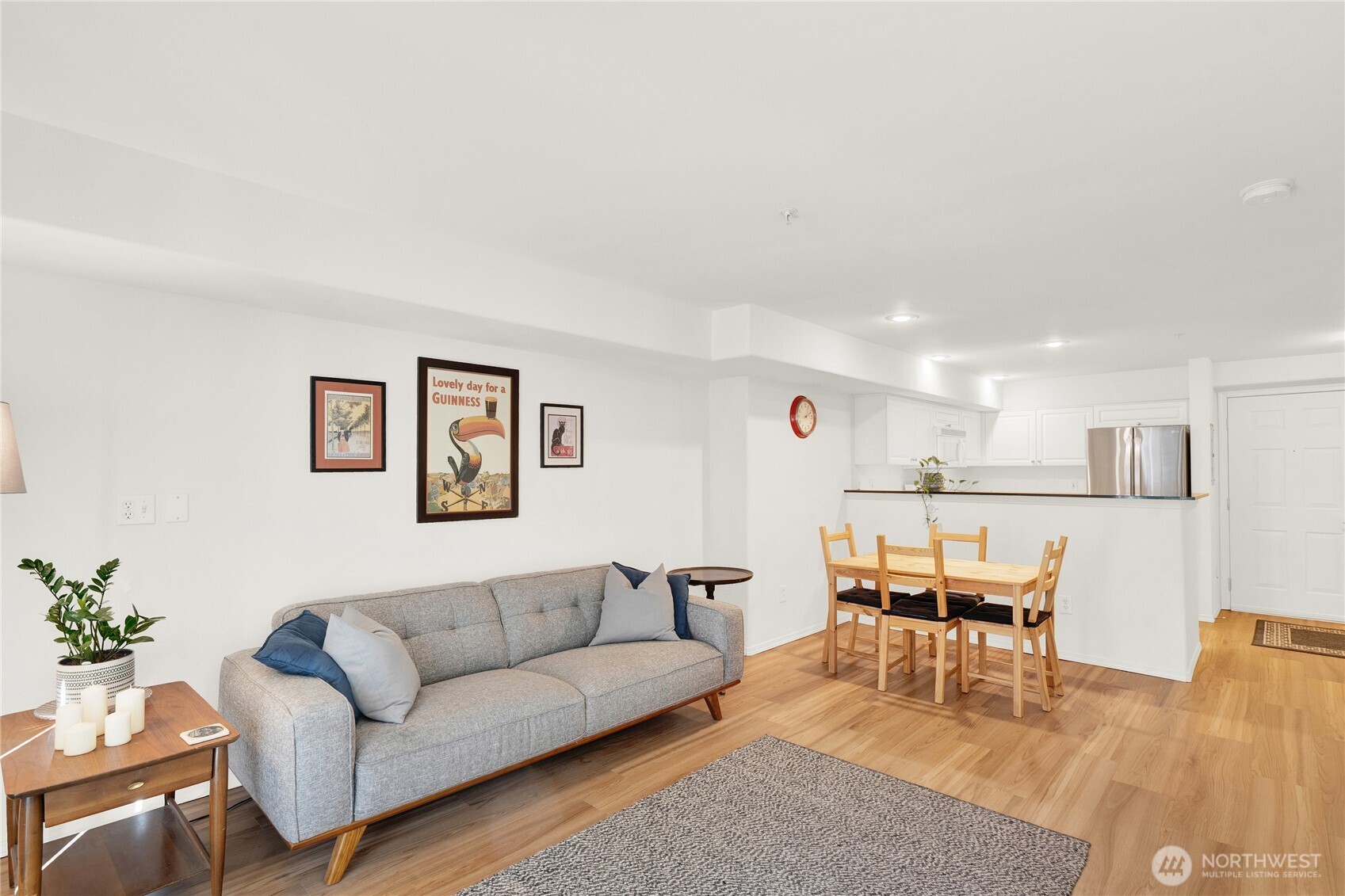 a living room with furniture and view of kitchen