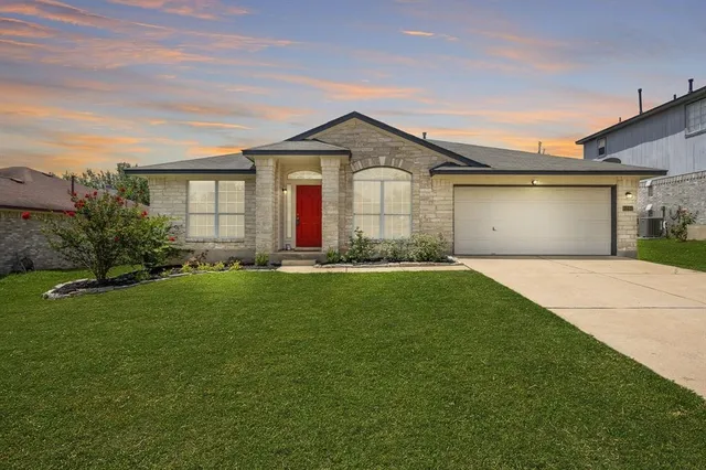 a front view of house with yard and green space