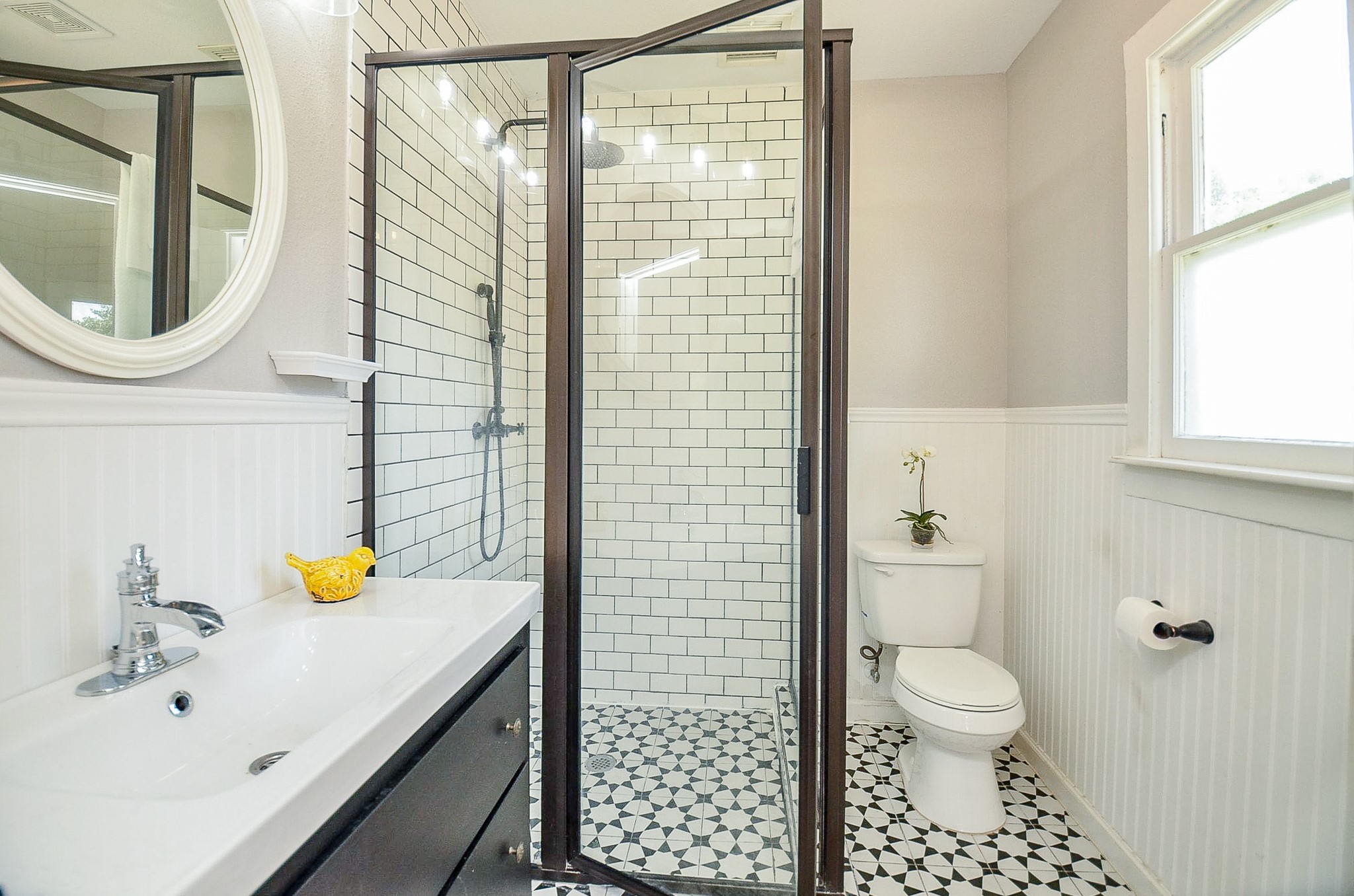 1615 Eagle Lake Road Sealy, TX 77474 - Photo 11 of 19 An updated bathroom features vanity with sink, glass enclosed shower with decorative tile that is so charming!