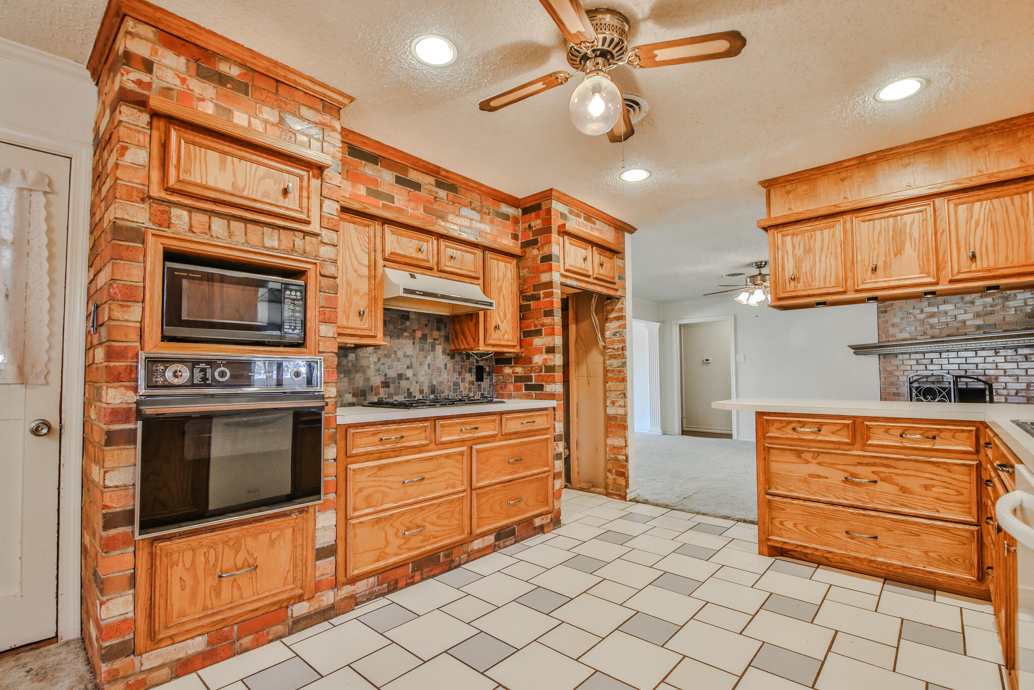 4315 47th Street Lubbock, TX 79413 - Photo 13 of 37 a kitchen with stainless steel appliances granite countertop a stove and a refrigerator