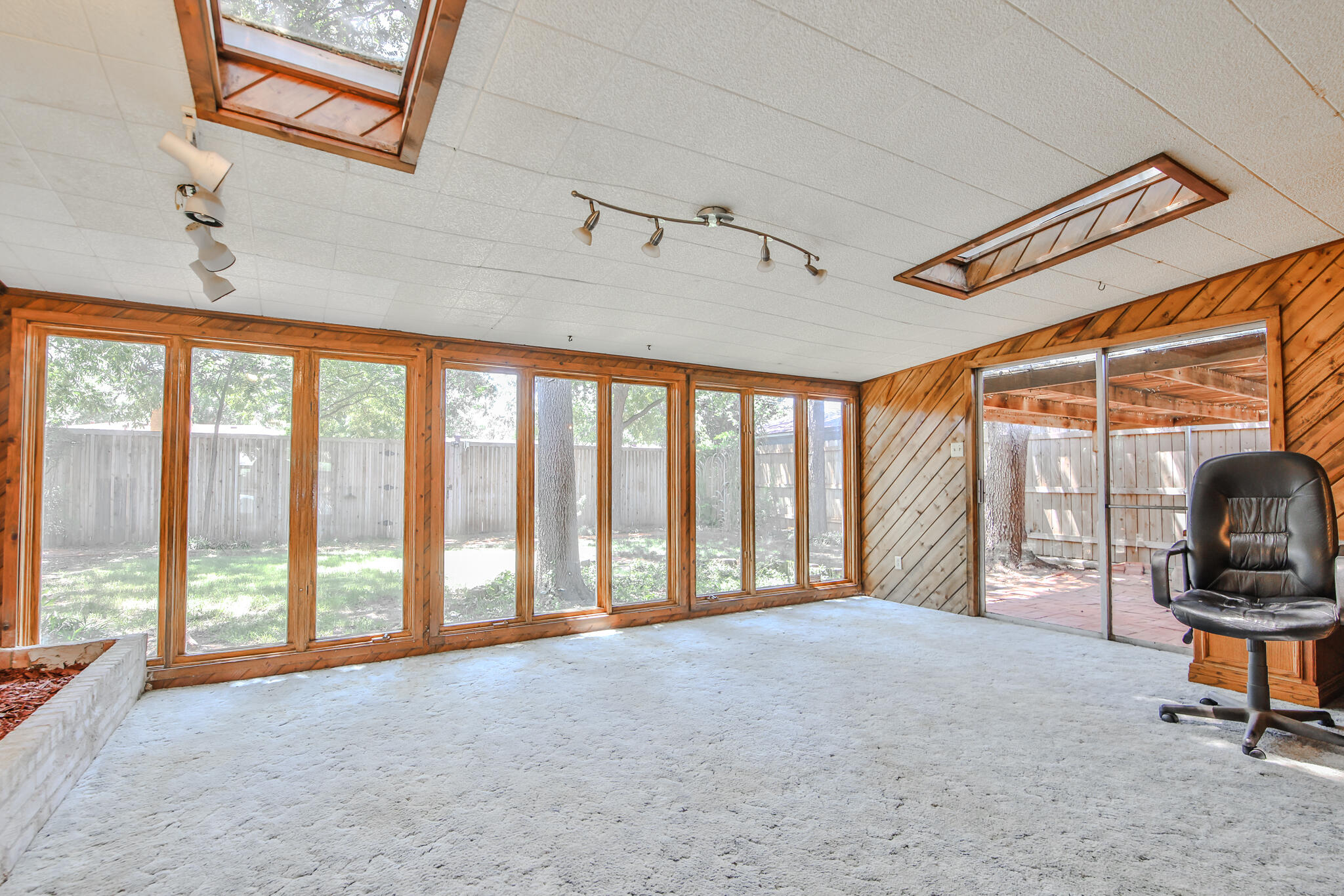 4315 47th Street Lubbock, TX 79413 - Photo 15 of 37 a view of a room with workspace and windows