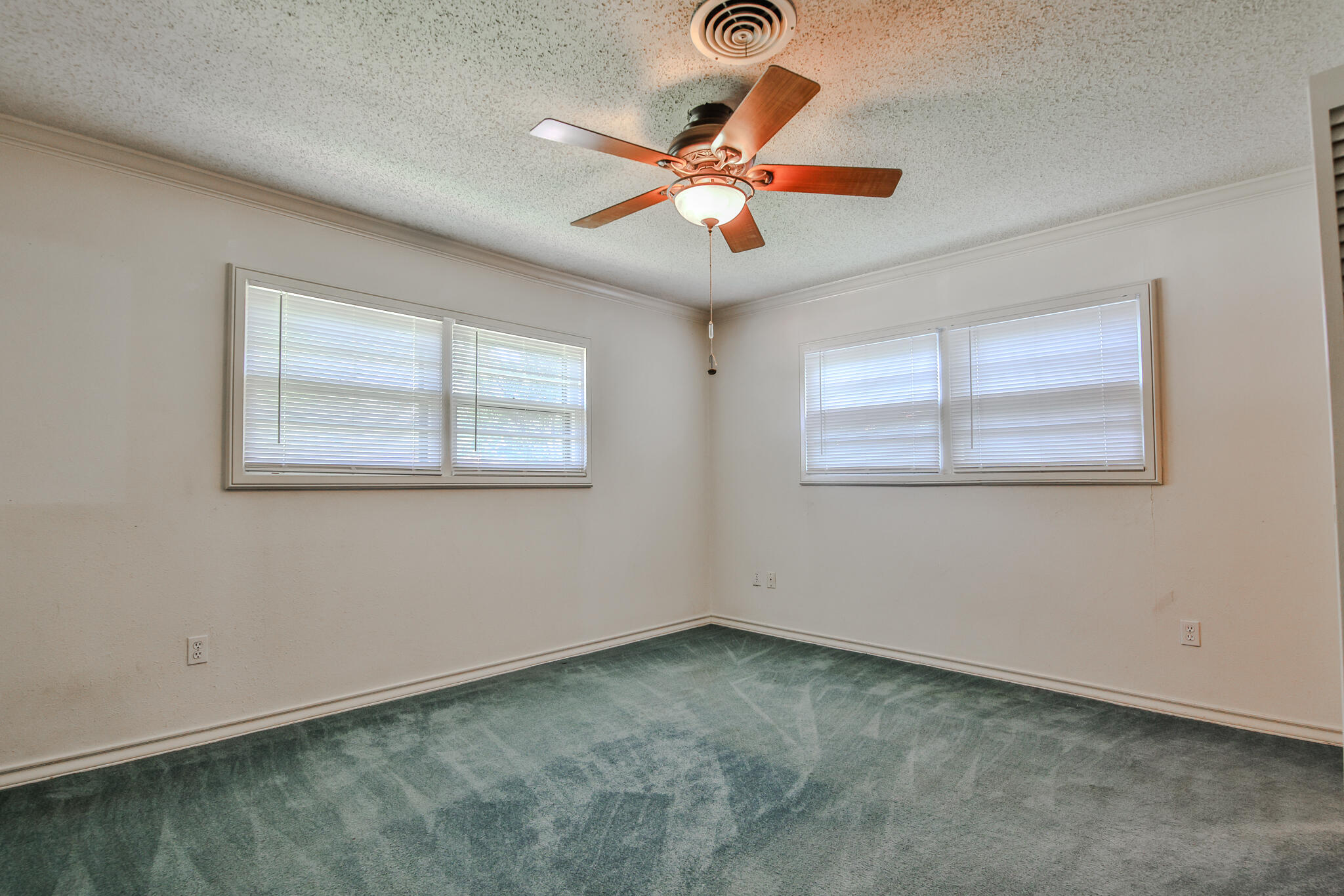 4315 47th Street Lubbock, TX 79413 - Photo 17 of 37 an empty room with a ceiling fan and window