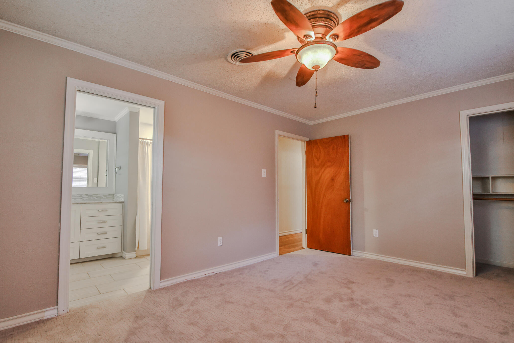 4315 47th Street Lubbock, TX 79413 - Photo 27 of 37 an empty room with closet and a chandelier fan