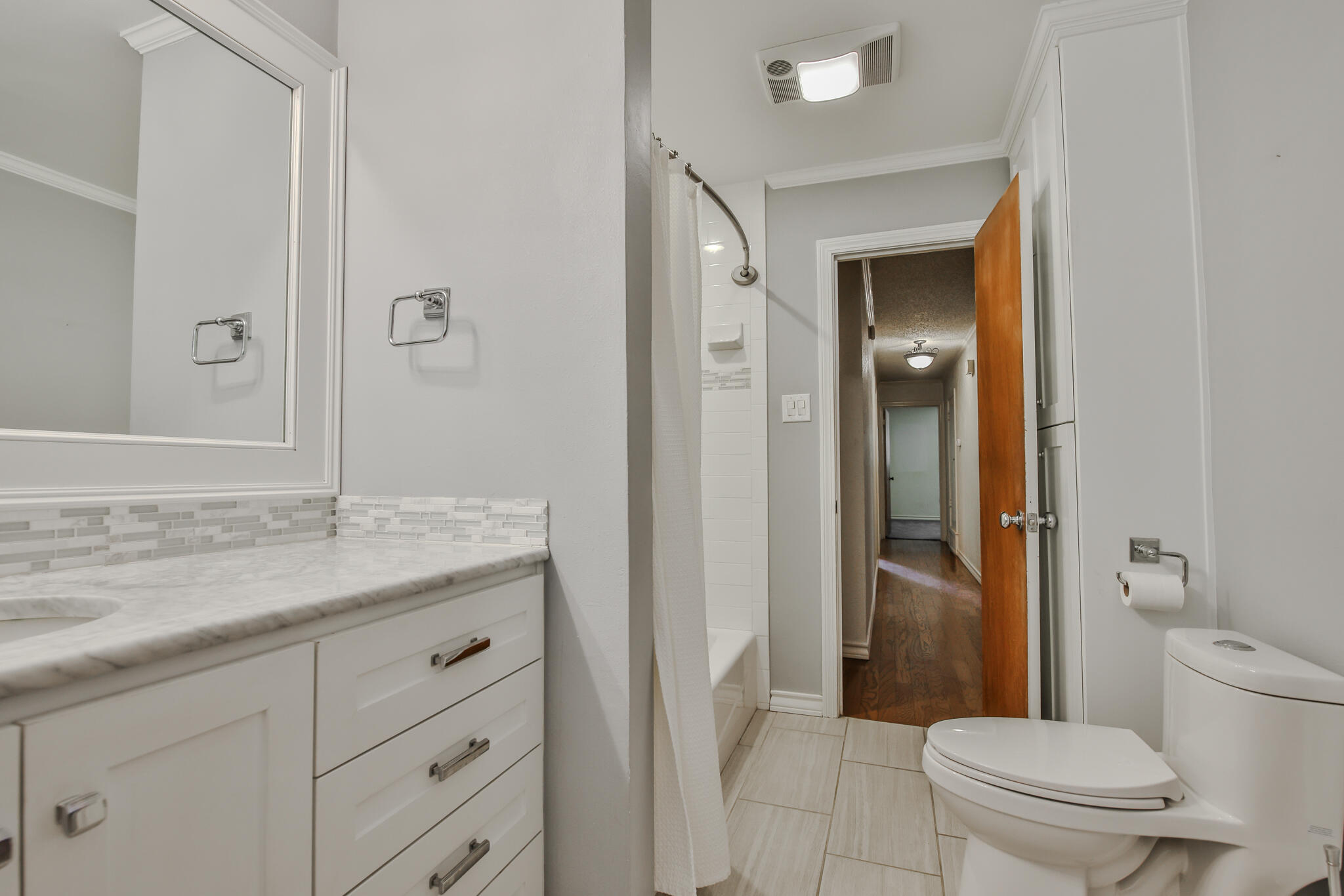 4315 47th Street Lubbock, TX 79413 - Photo 30 of 37 a bathroom with a granite countertop sink toilet and shower