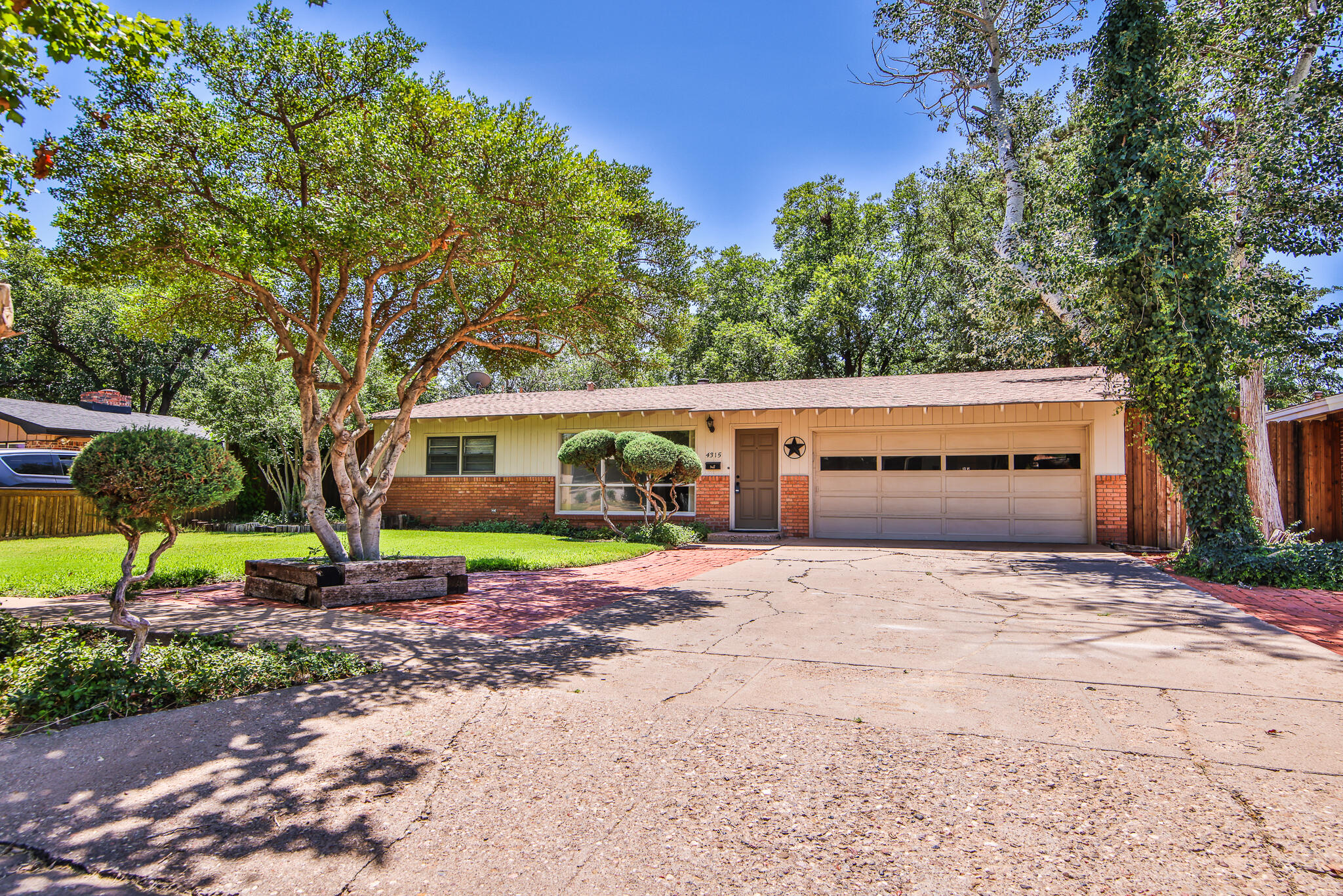 4315 47th Street Lubbock, TX 79413 - Photo 3 of 37 a front view of a house with garden
