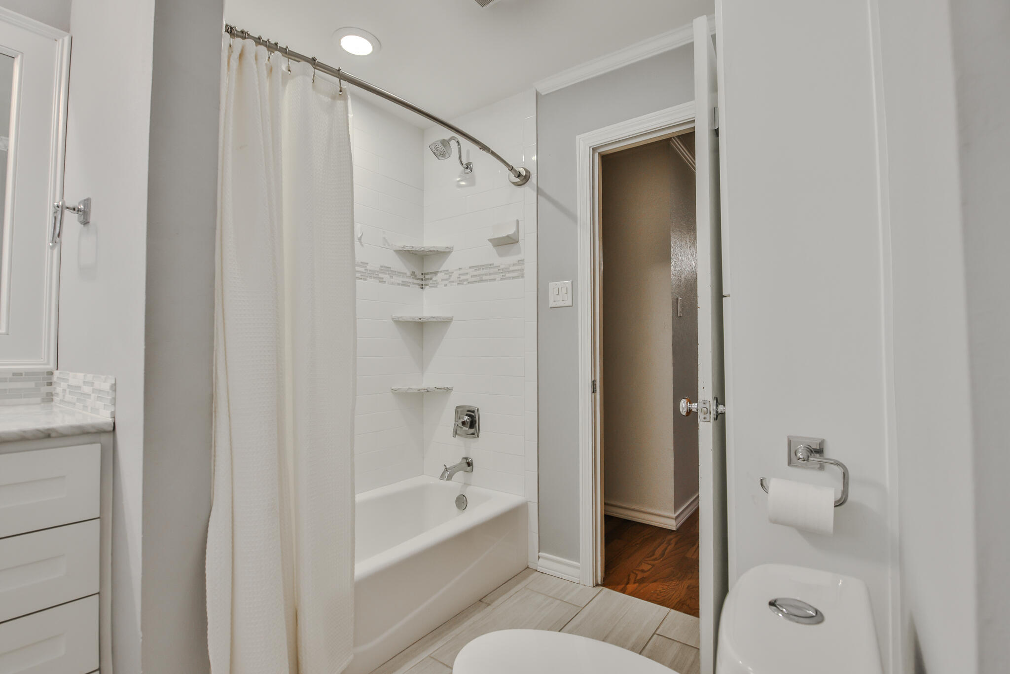 4315 47th Street Lubbock, TX 79413 - Photo 31 of 37 a bathroom with a bathtub and a shower