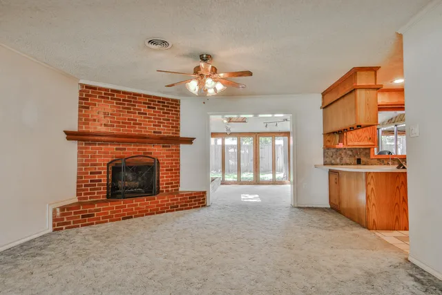 a view of a fireplace and window in a room
