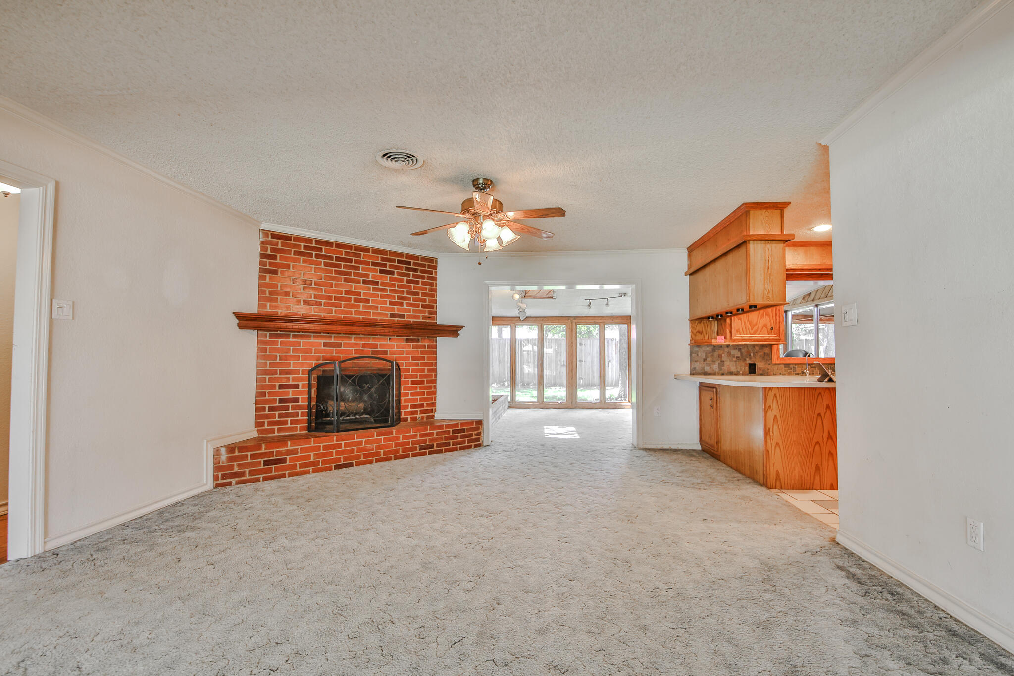 4315 47th Street Lubbock, TX 79413 - Photo 9 of 37 a view of a fireplace and window in a room