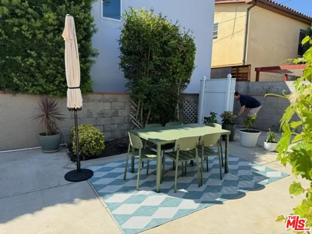 a view of a tables and chairs in back yard of the house