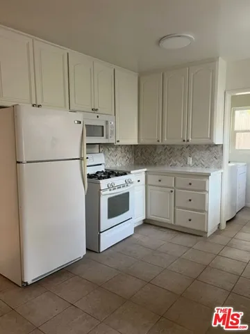 a white refrigerator freezer sitting in a kitchen