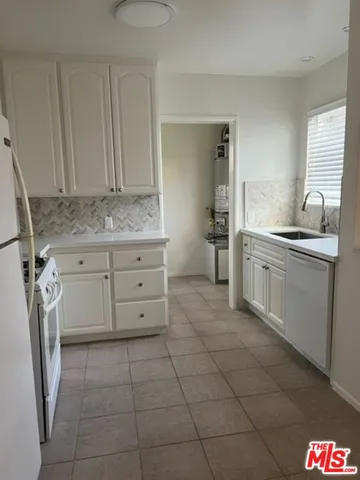 a kitchen with a stove a sink and a refrigerator