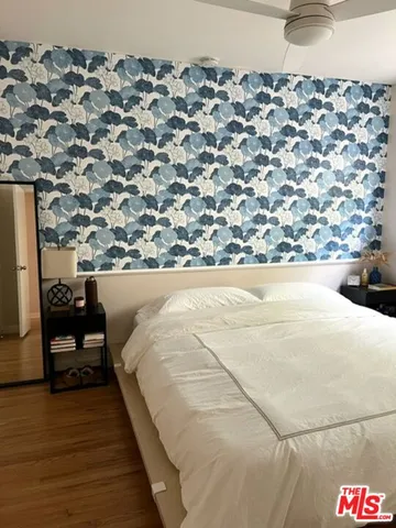 a bed sitting in a bedroom next to a lamp