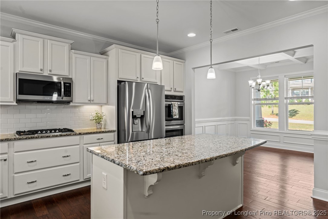 335 Parrish Lane Carthage, NC 28327 - Photo 13 of 50 a kitchen with granite countertop a refrigerator and a stove top oven