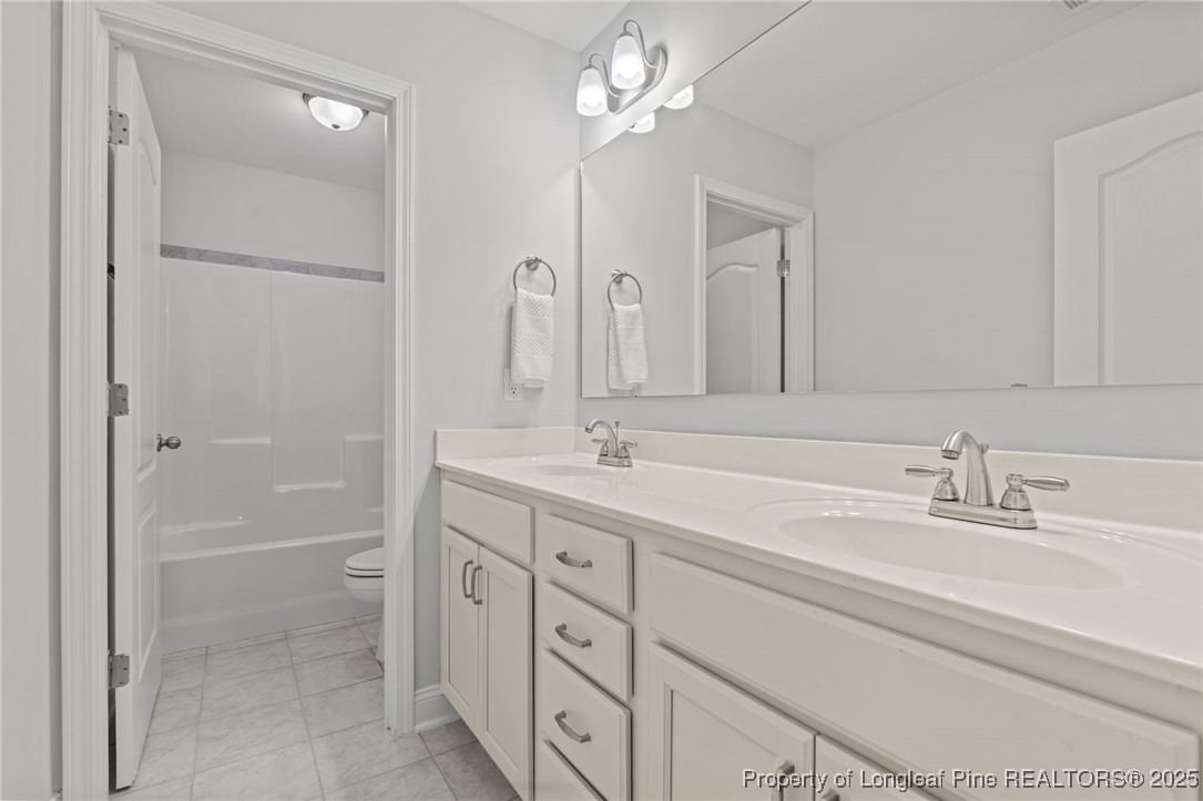 335 Parrish Lane Carthage, NC 28327 - Photo 36 of 50 a bathroom with a double vanity sink a mirror and a shower