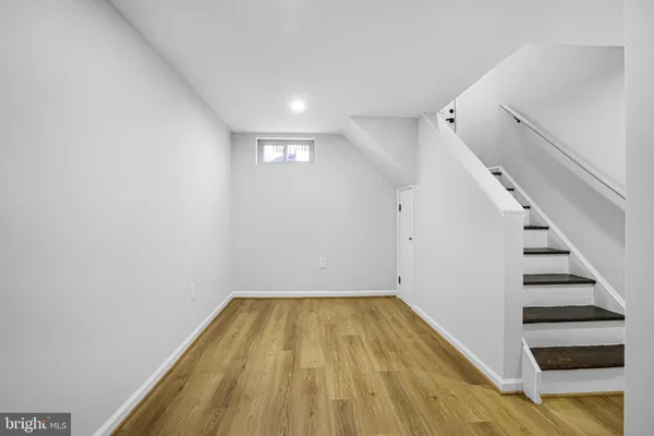 a view of a room with wooden floor and white walls