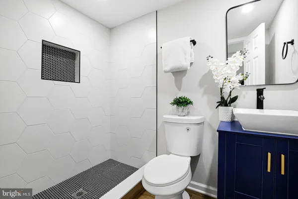 a bathroom with a toilet a sink and mirror