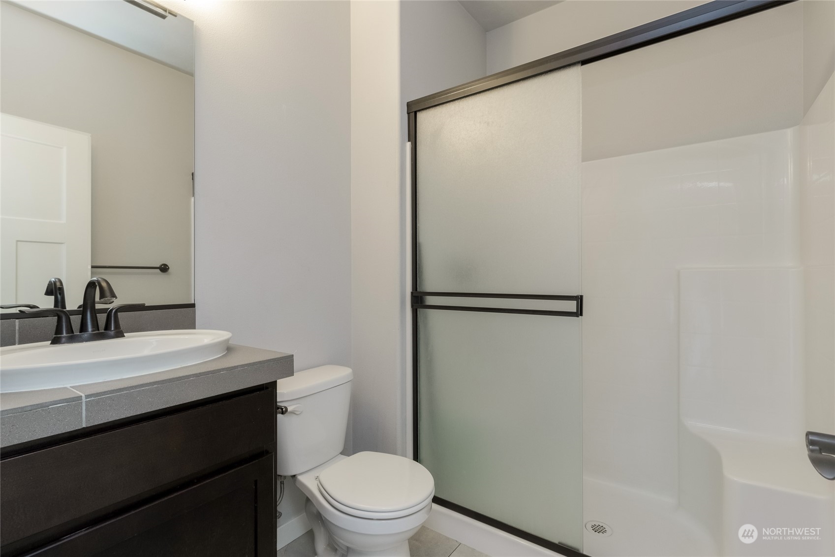 862 Boulder Street Walla Walla, WA 99362 - Photo 26 of 38 a bathroom with a sink a toilet a mirror and shower