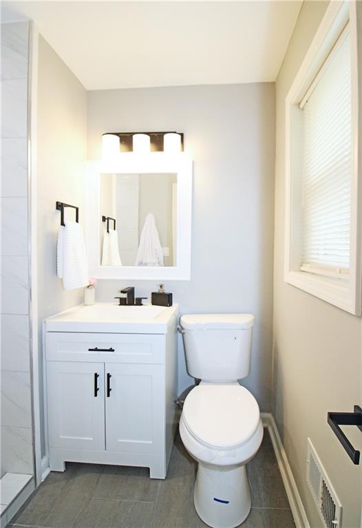 2450 Elkhorn Drive Decatur, GA 30034 - Photo 14 of 32 a bathroom with a toilet a sink a vanity and mirror