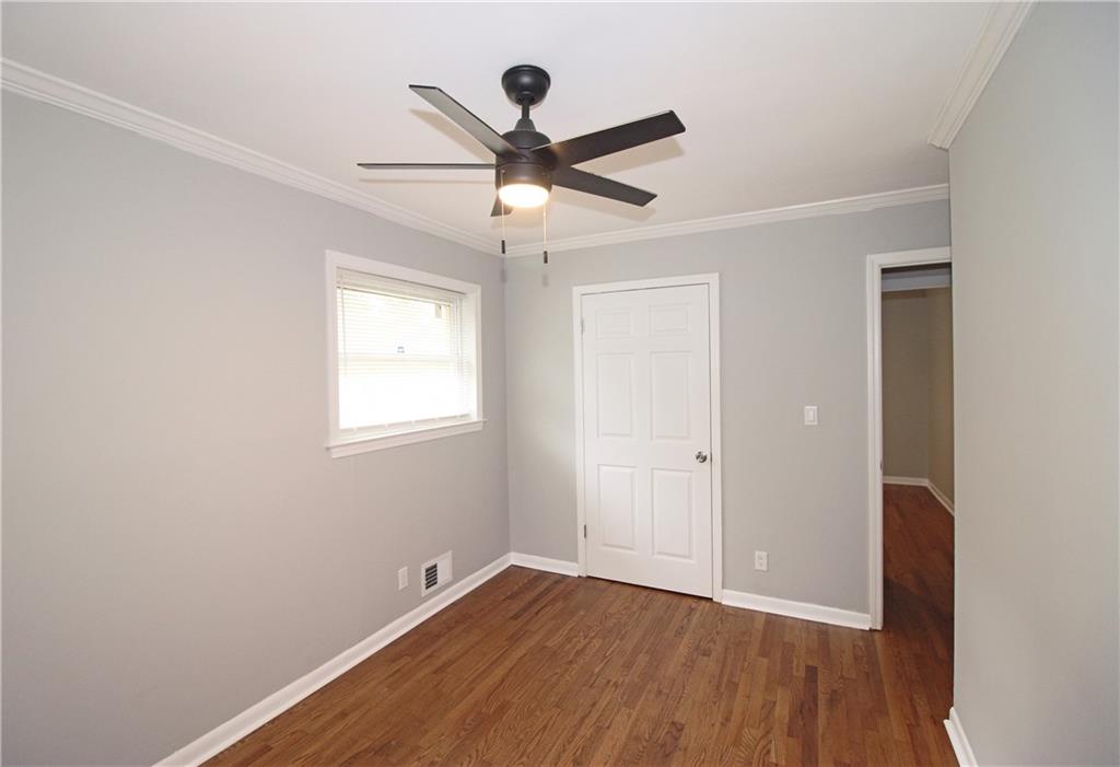 2450 Elkhorn Drive Decatur, GA 30034 - Photo 17 of 32 a view of an empty room with wooden floor and a ceiling fan